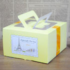 Gelber Papierkasten, der für den verpackenden Kuchen, faltbare Tortenschachtel mit Griff verpackt
